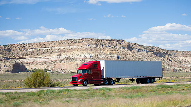 a semi truck on the road in the desert