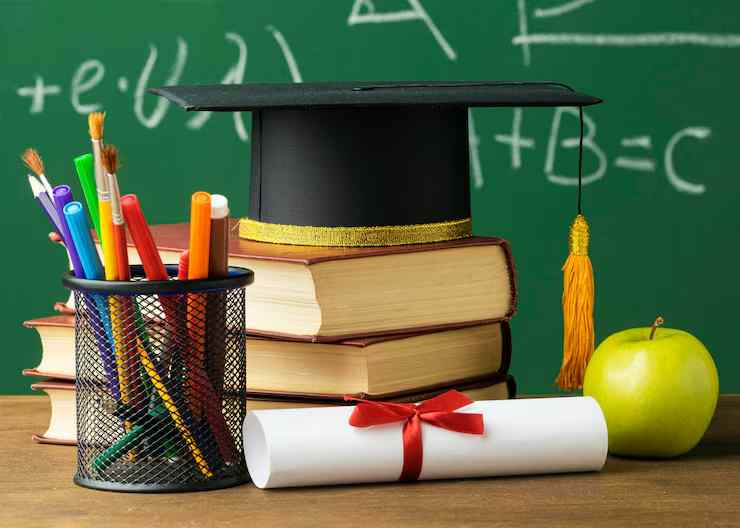 RICS Membership Guide 2026: Everything You Need to Know front view academic cap with books pencils 23 2148756619 (1)